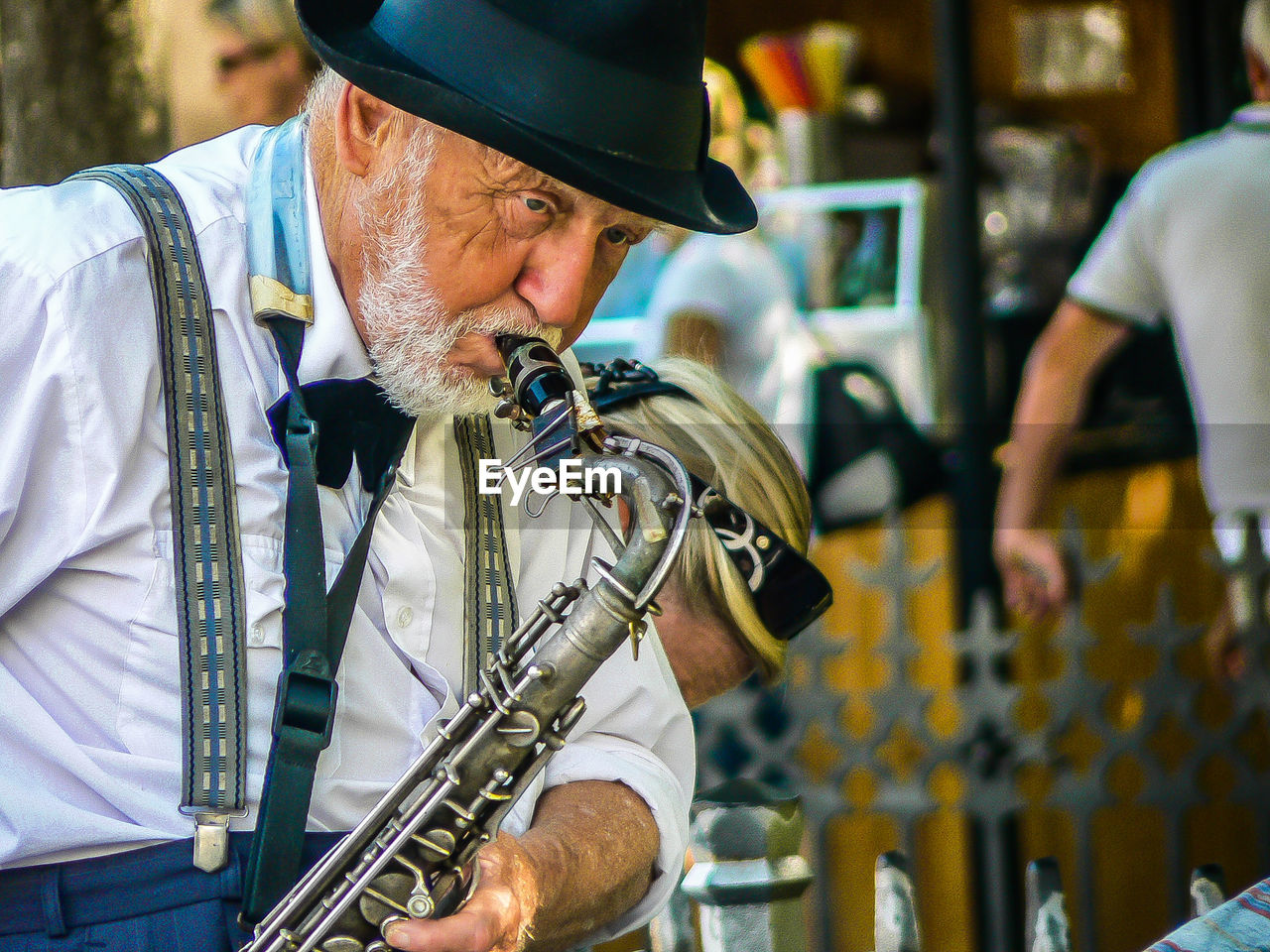 LOW ANGLE VIEW OF MAN PLAYING MUSIC AT CONCERT