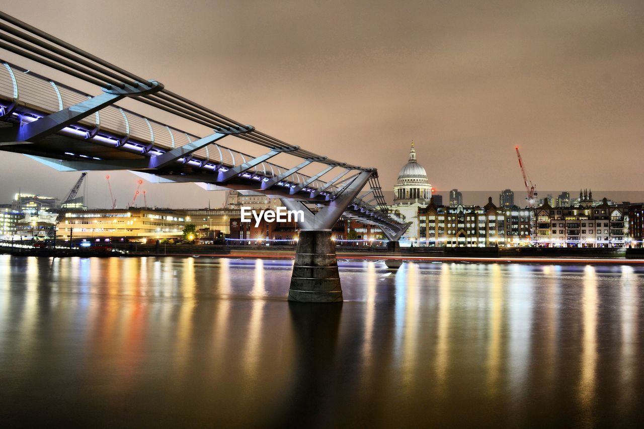 View of bridge over river at night