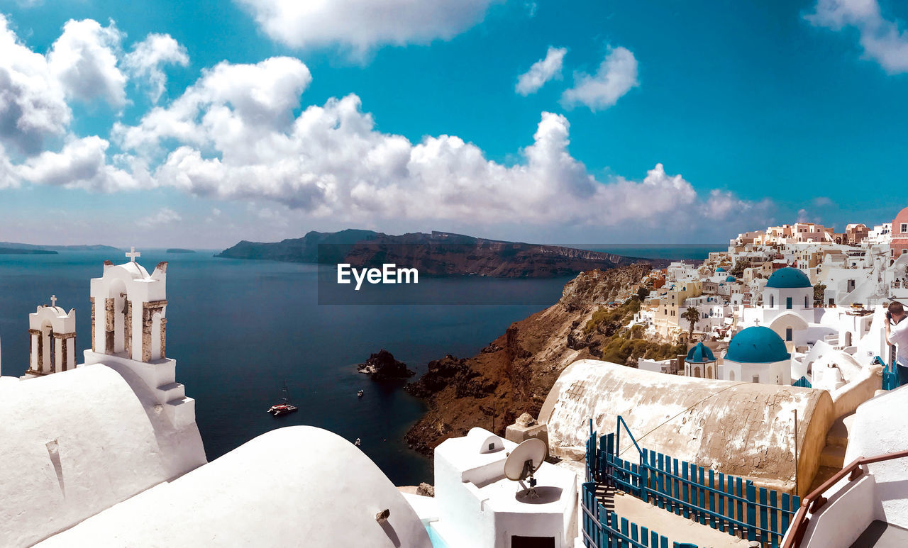 Panoramic view of buildings and sea against sky