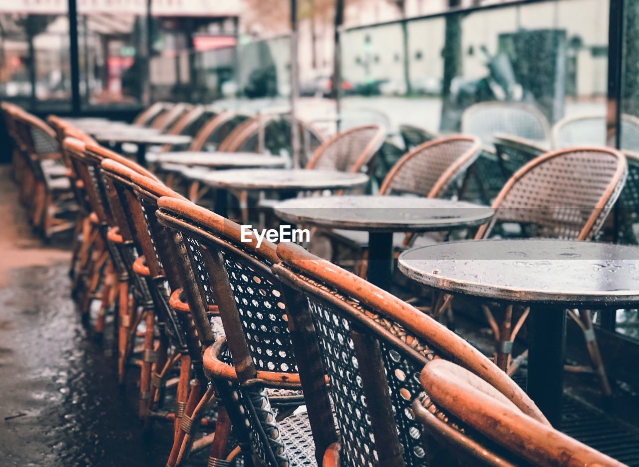 Empty tables and chairs arranged in restaurant