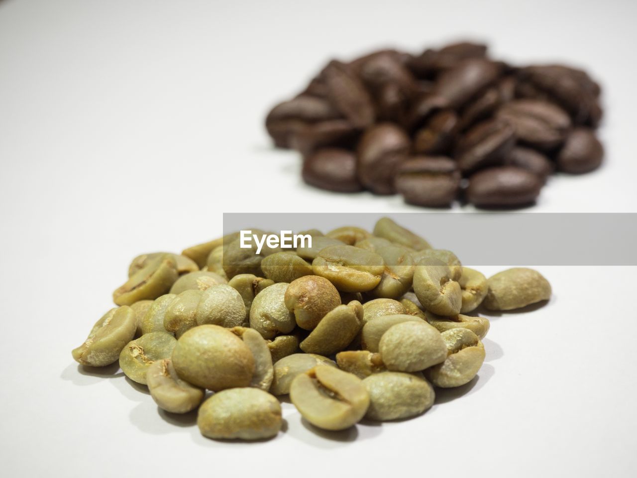 Close-up of coffee beans against white background