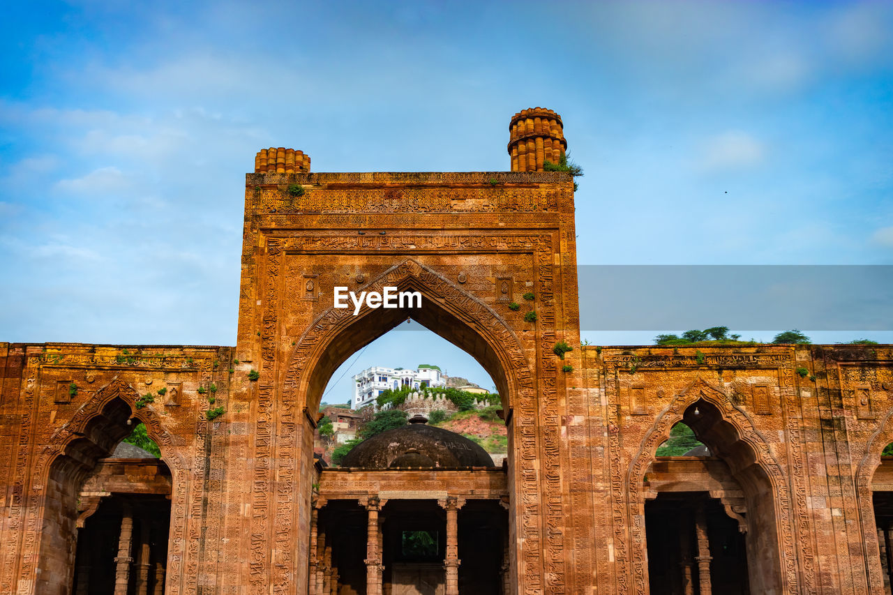 Ancient grand mosque called adhai din ka jhonpra vintage architecture with bright blue sky 