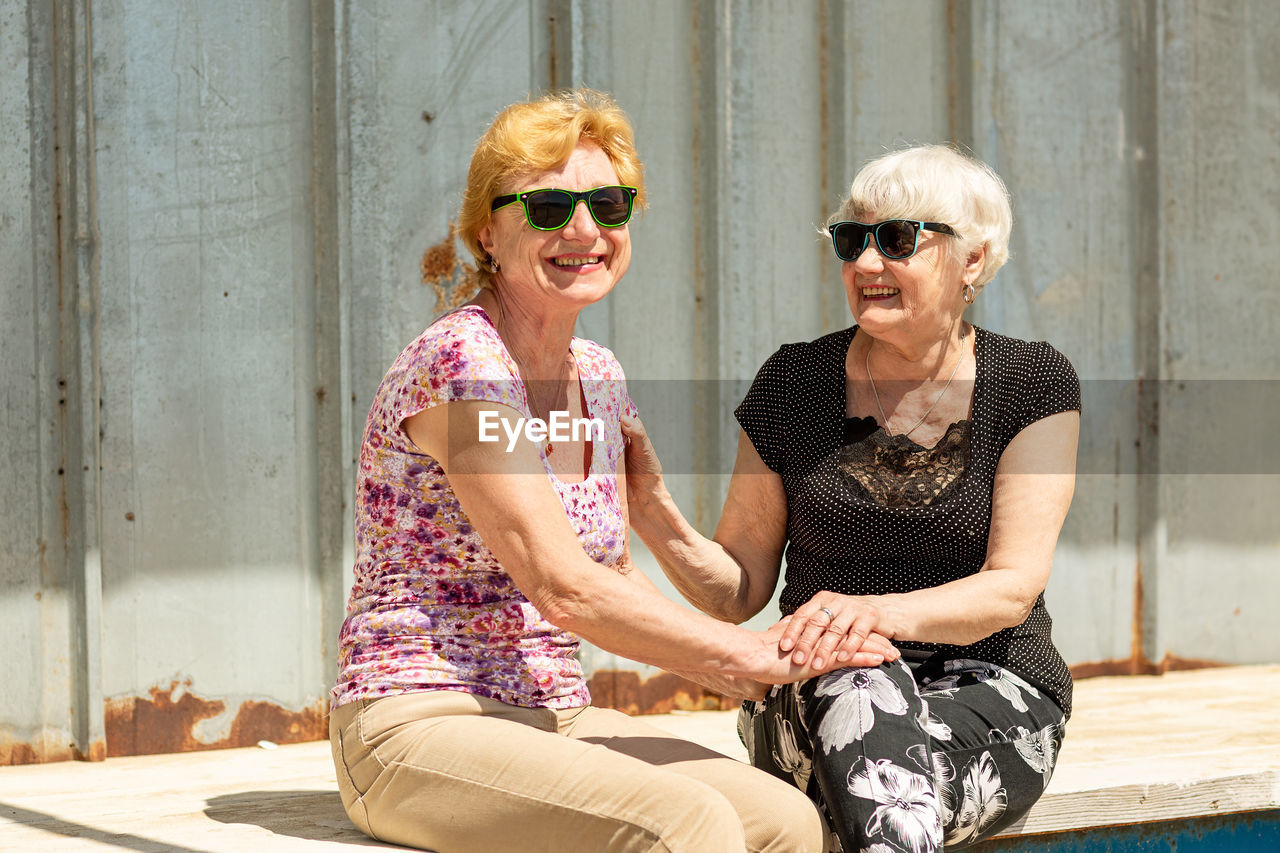 Two elderly women are happy to meet each other