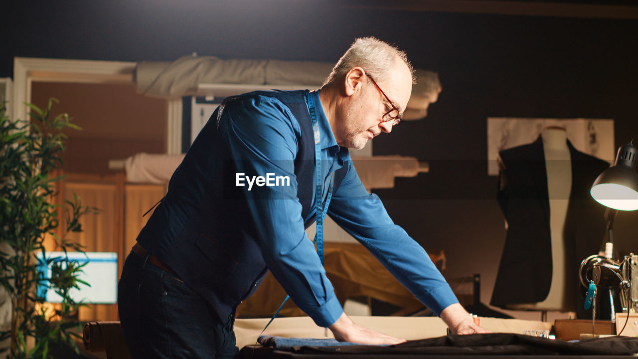 side view of young man working at home