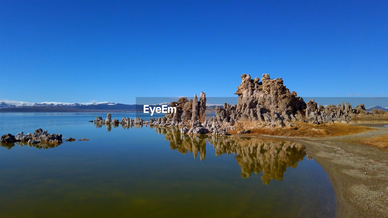 ROCK FORMATIONS AGAINST BLUE SKY