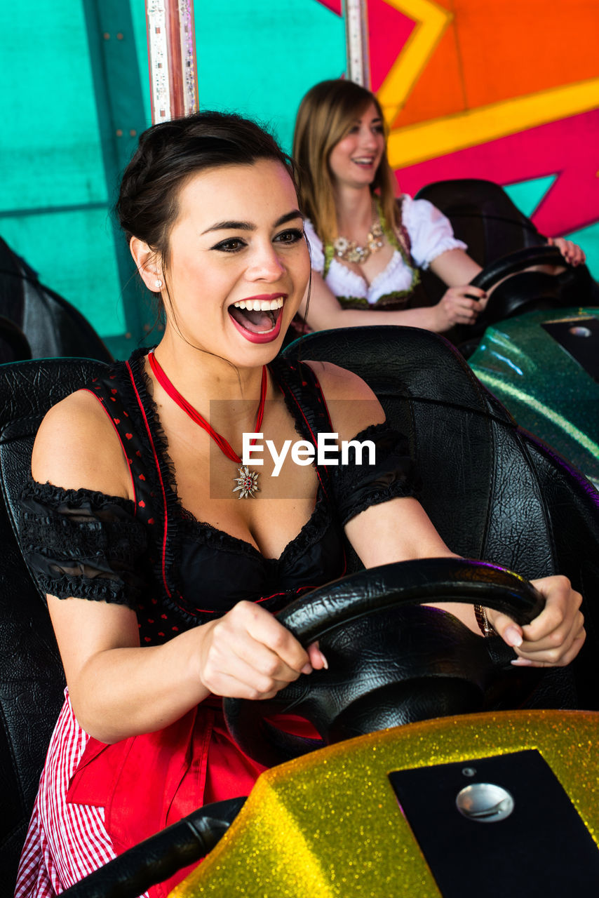 Happy women enjoying in bumper cars