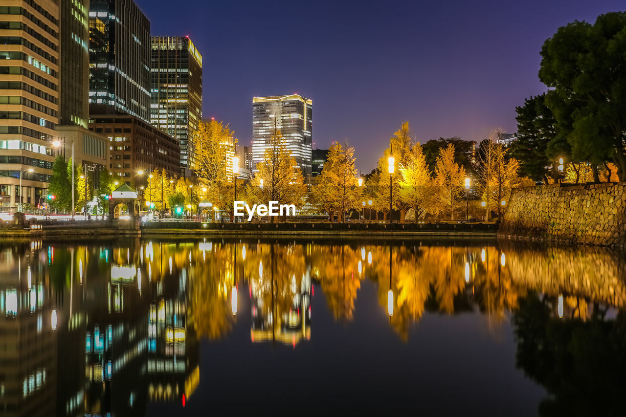 Reflection of illuminated buildings in lake at night