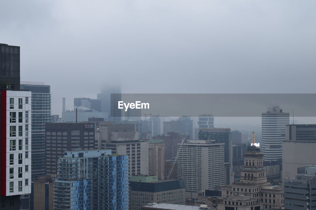 Modern buildings in city against clear sky