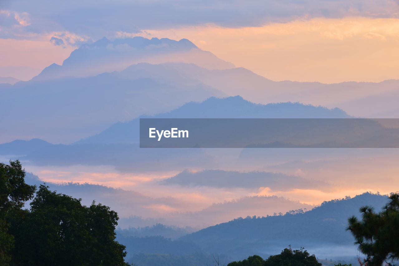 Scenic view of silhouette mountains against sky at sunset