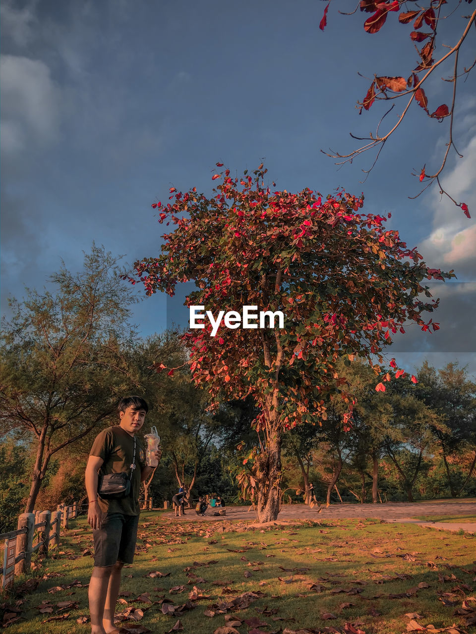 Full length of man standing on field against sky on tanah lot