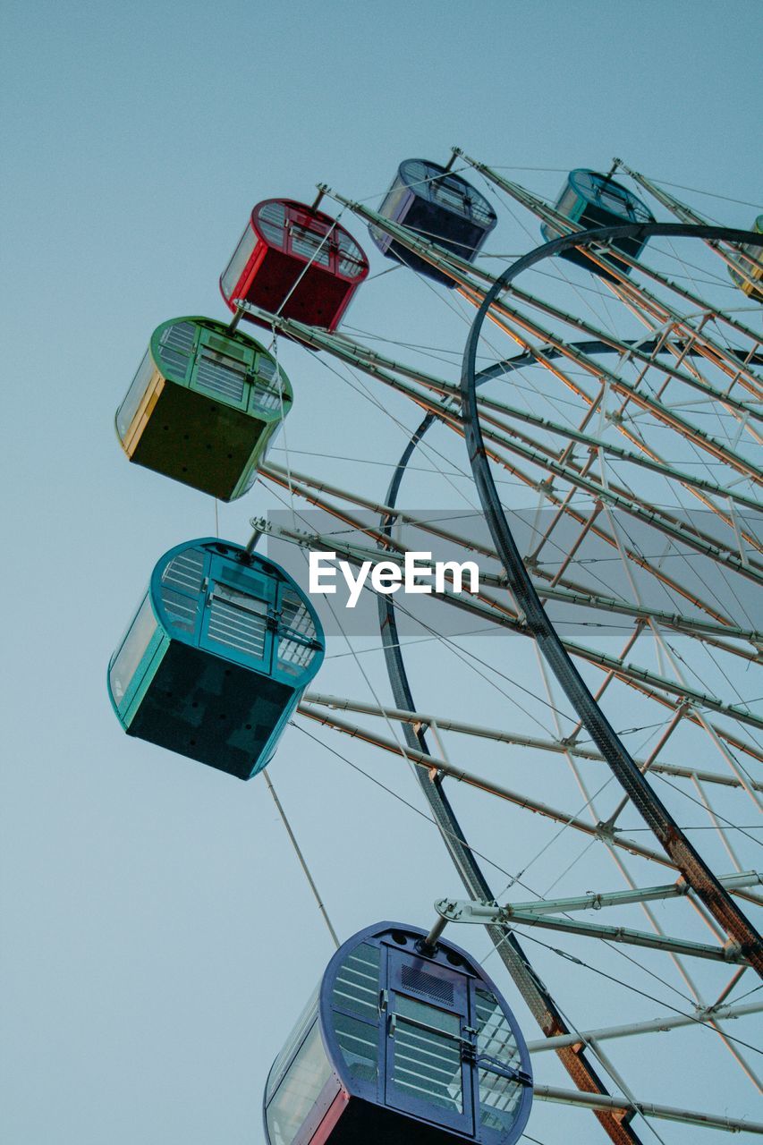 Low angle view of ferris wheel against clear sky