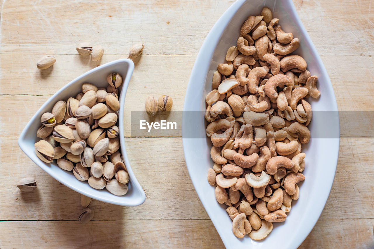 High angle view of walnuts and cashews in bowl on table
