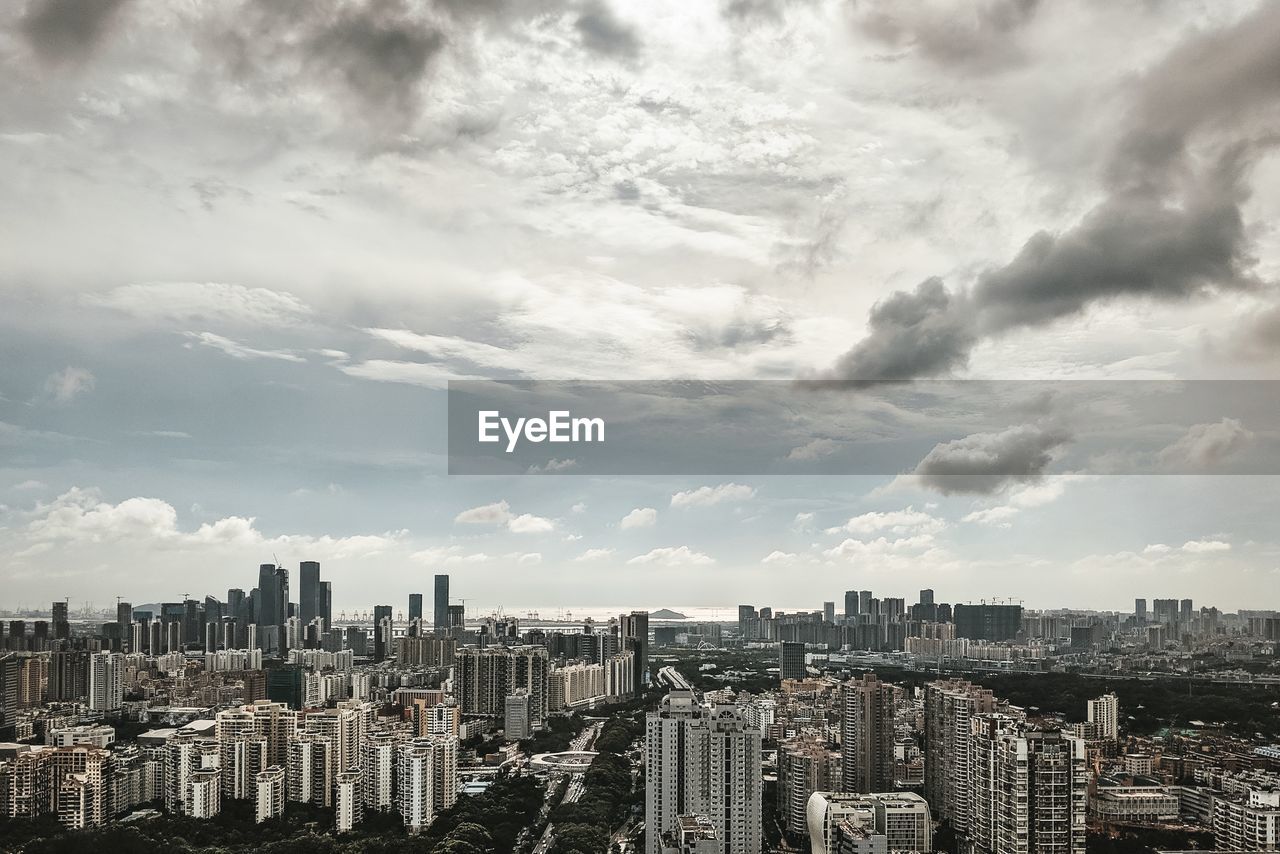 Aerial view of modern buildings in city against sky