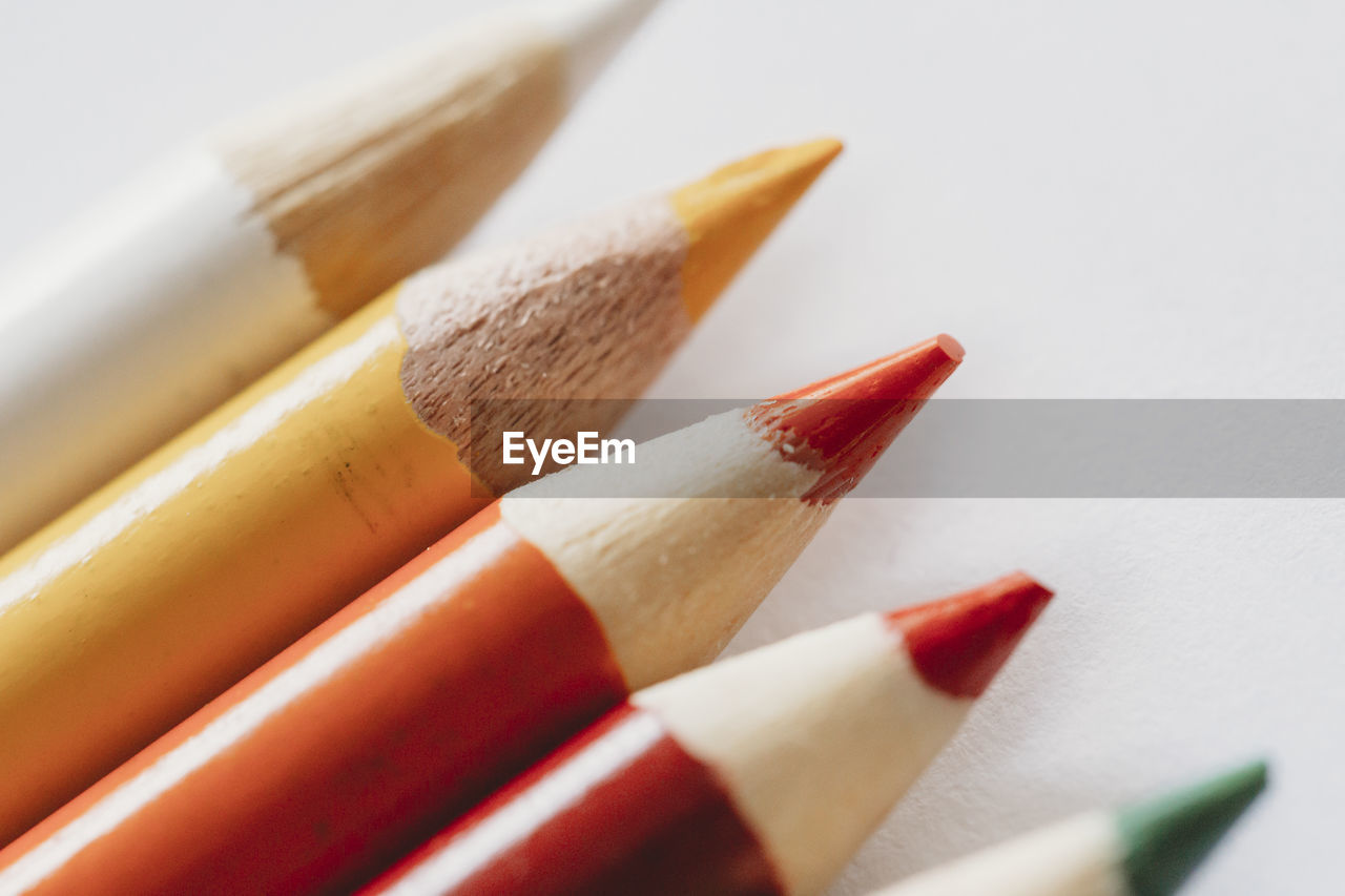 Macro view of red orange yellow coloring pencils