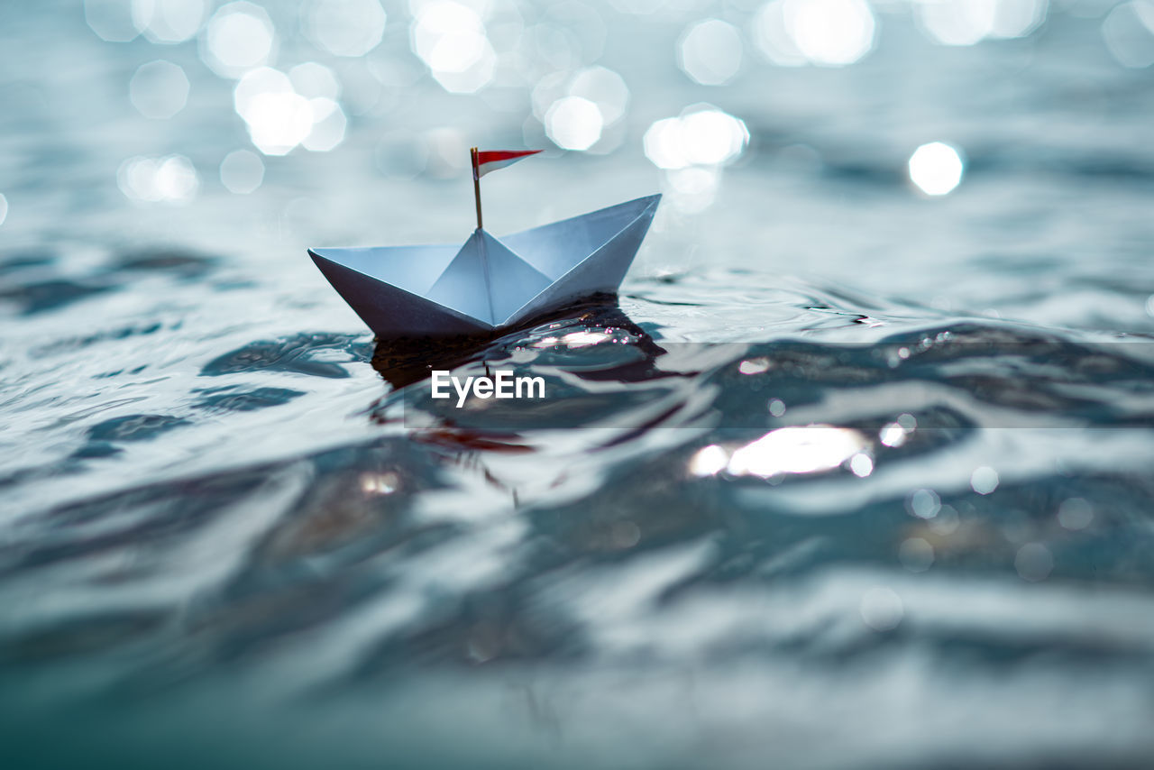 Close-up of paper boat floating on water