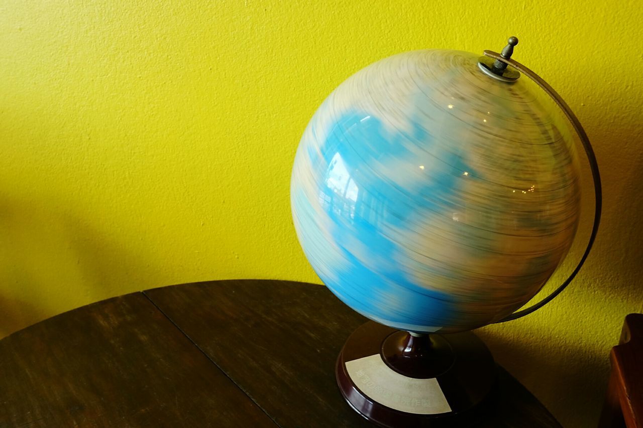 Close-up of spinning globe on table