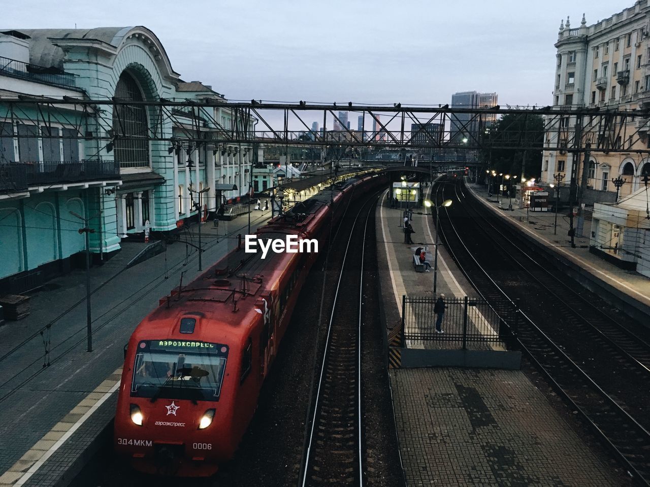 Train on railroad tracks in city against sky