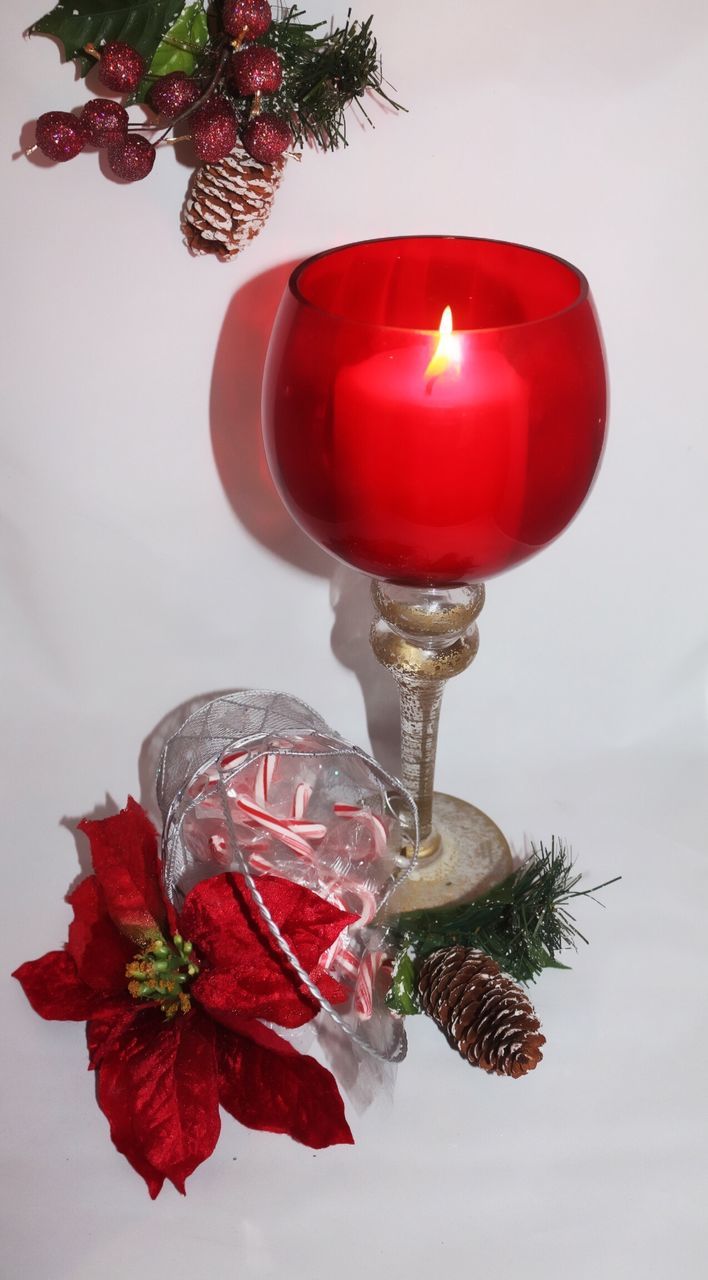 Close-up of illuminated candle in wineglass during christmas