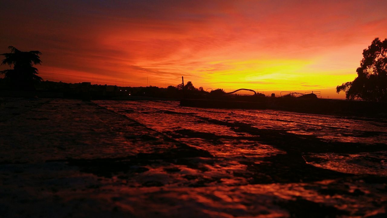 SILHOUETTE BEACH AGAINST SKY DURING SUNSET