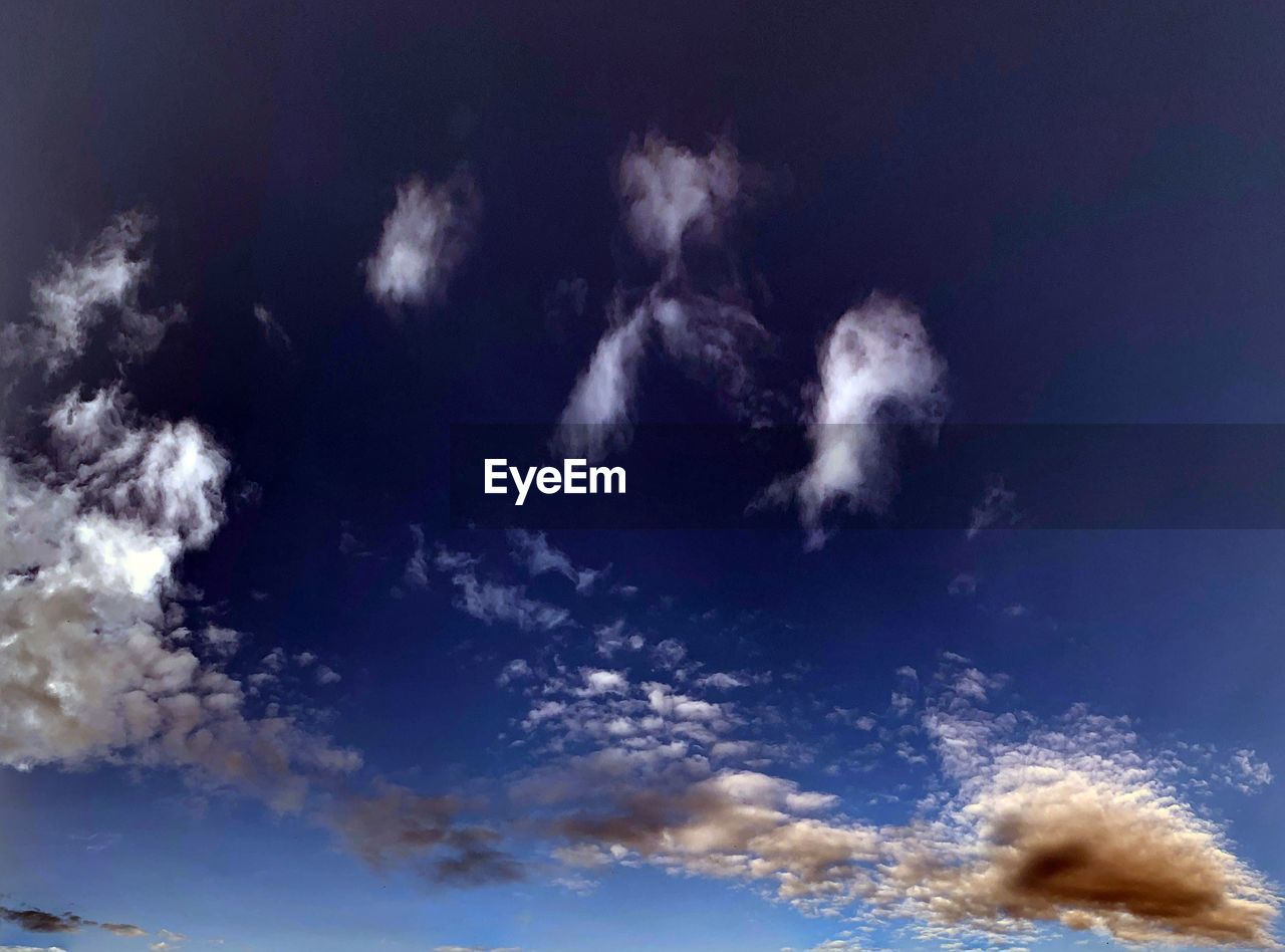 LOW ANGLE VIEW OF WHITE CLOUDS IN BLUE SKY