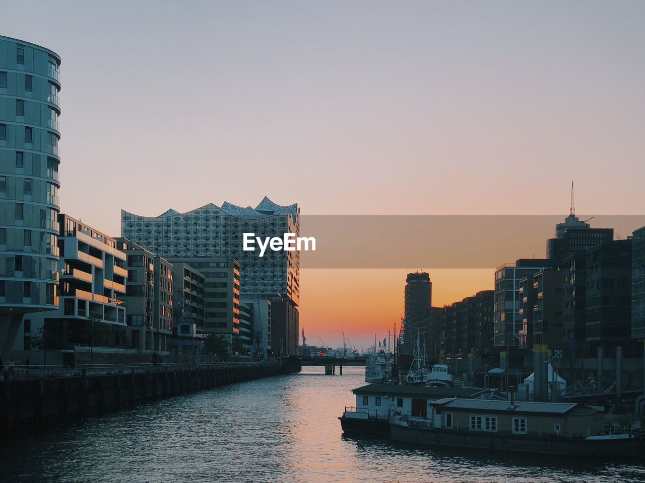 View of river and buildings against clear sky