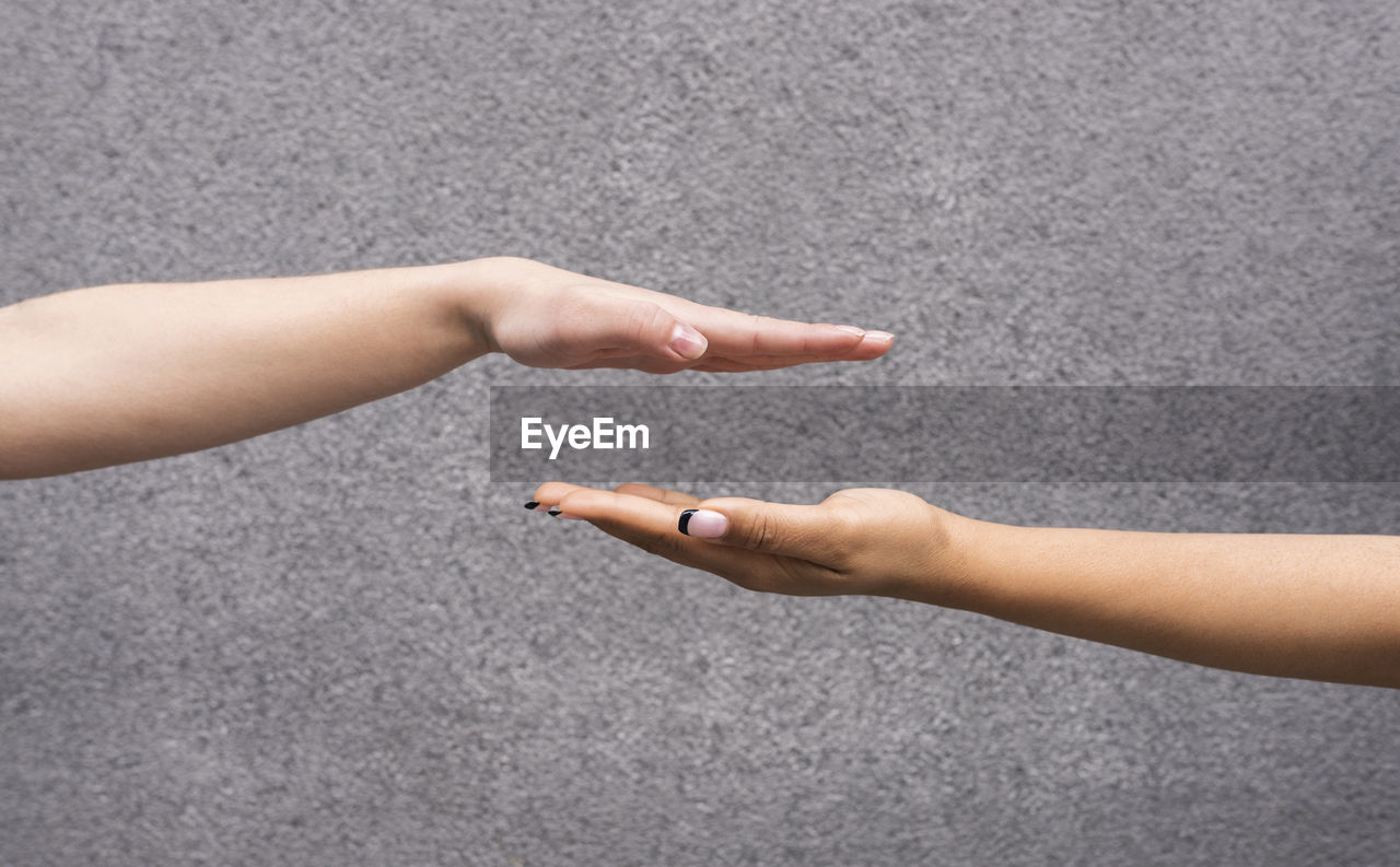 Studio shot of hands of two young women