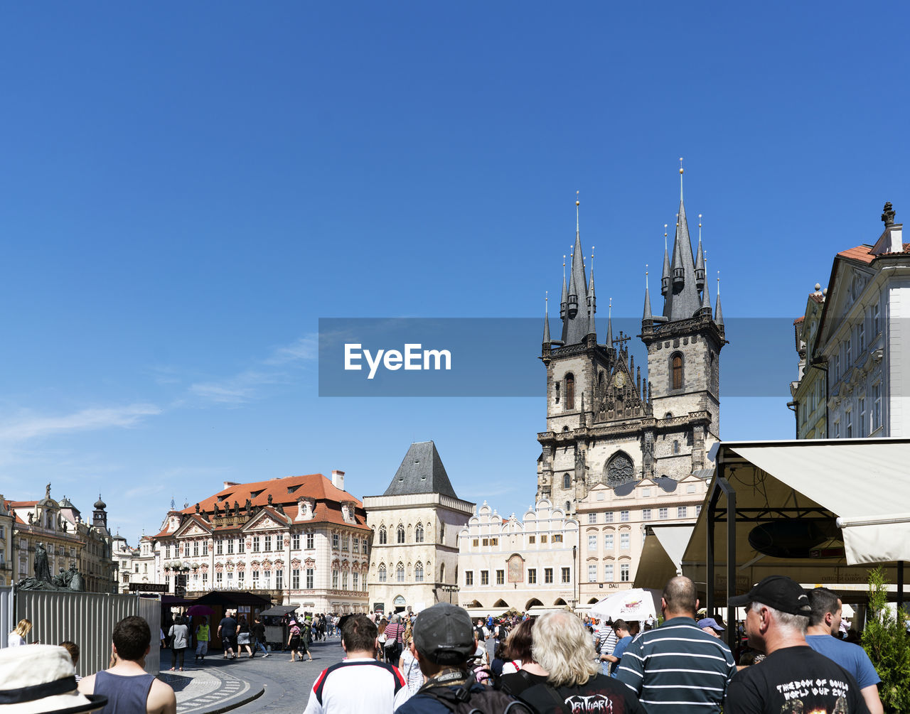 PEOPLE AT CATHEDRAL AGAINST BLUE SKY