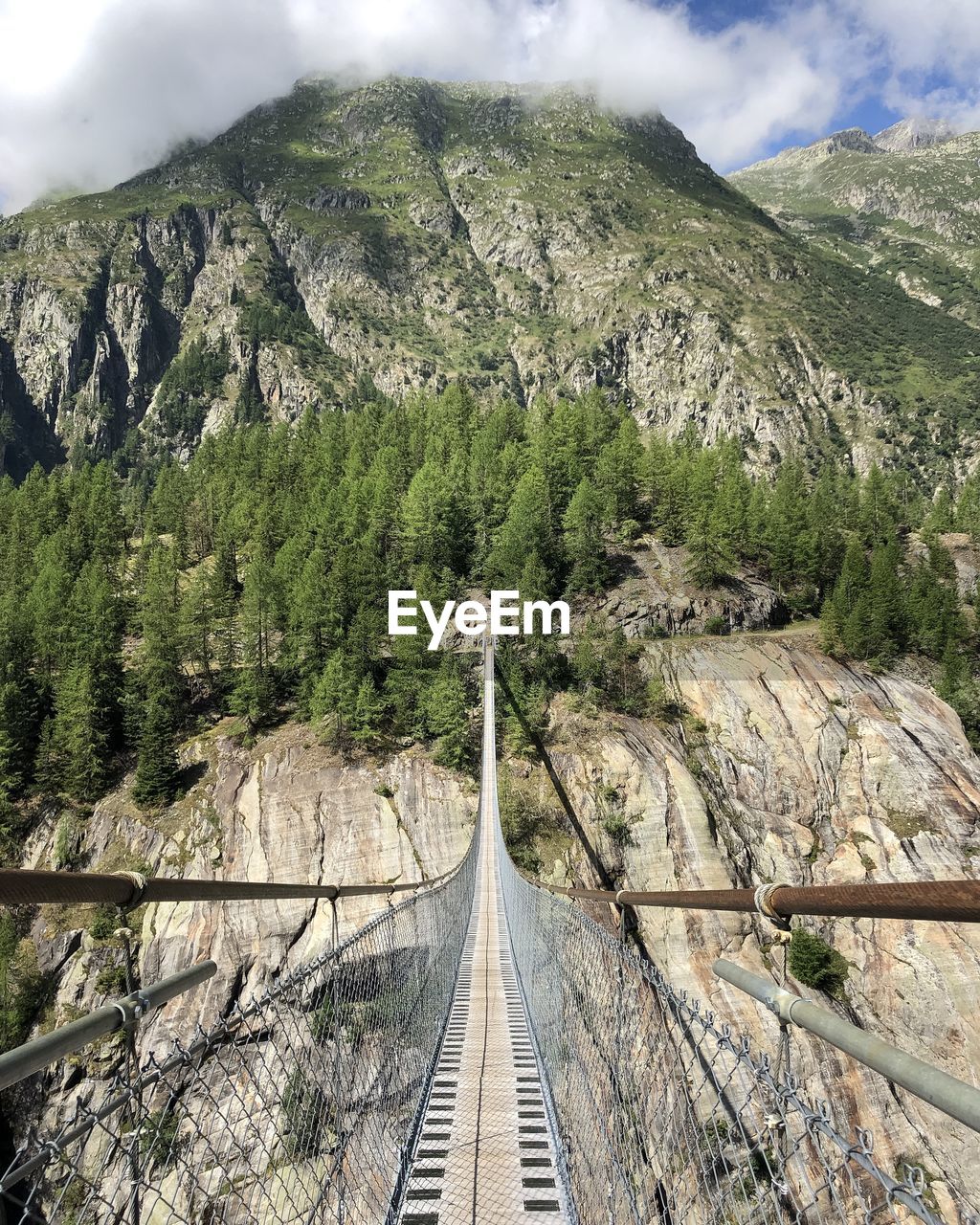 Suspension bridge in the mountains first person perspective 