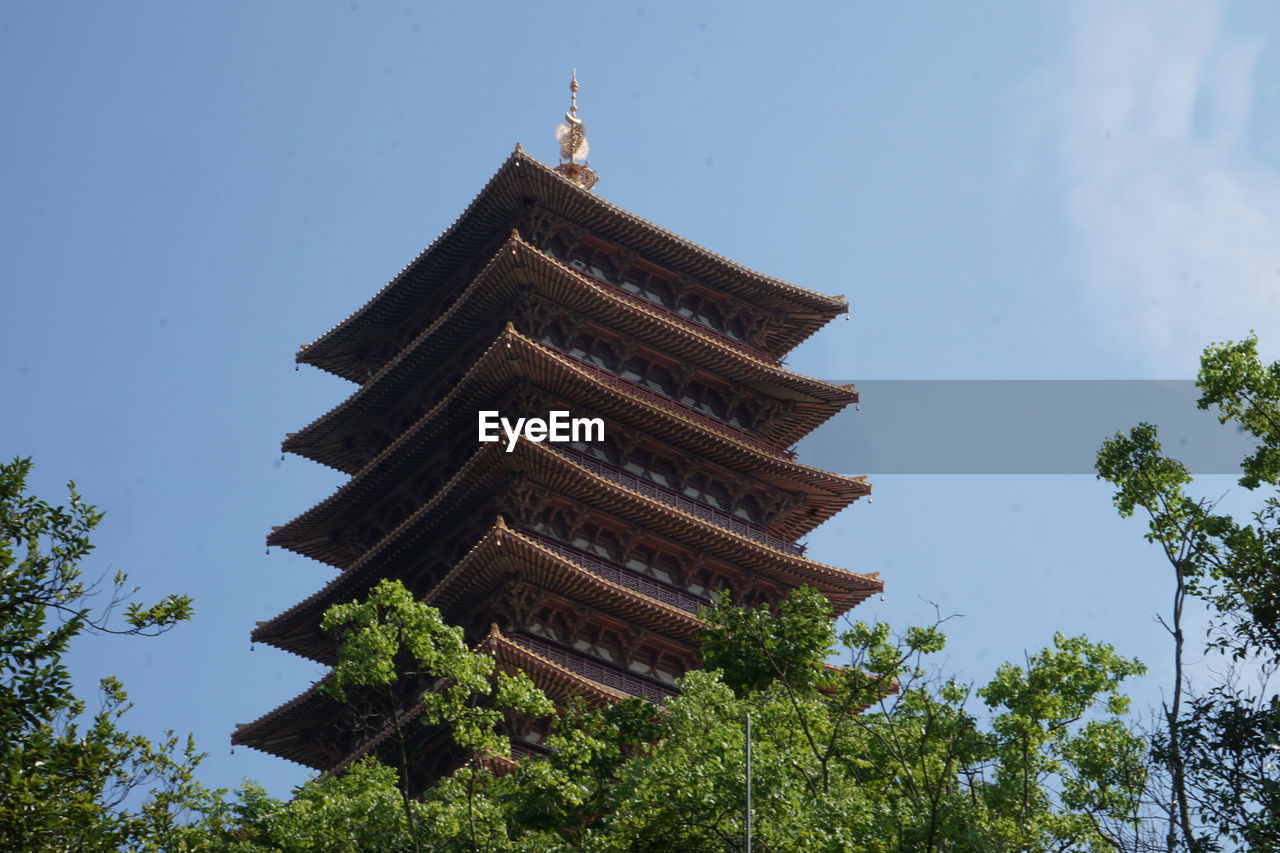 architecture, built structure, tower, tree, pagoda, plant, religion, sky, building exterior, temple - building, building, nature, belief, travel destinations, place of worship, history, spirituality, temple, no people, tradition, the past, travel, chinese architecture, low angle view, tourism, outdoors, blue, landmark, cloud, day, ancient, city, clear sky