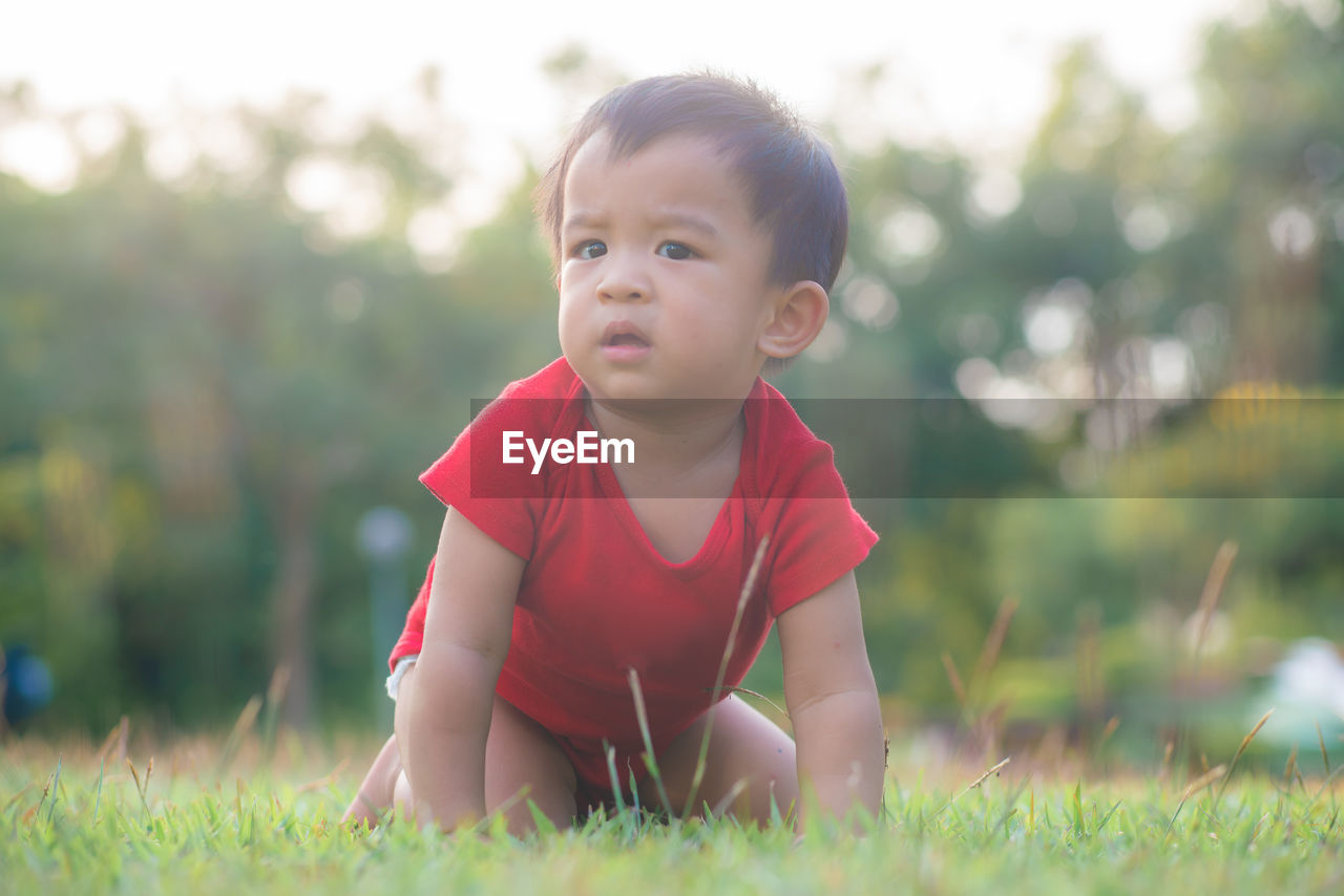 PORTRAIT OF CUTE BOY ON FIELD