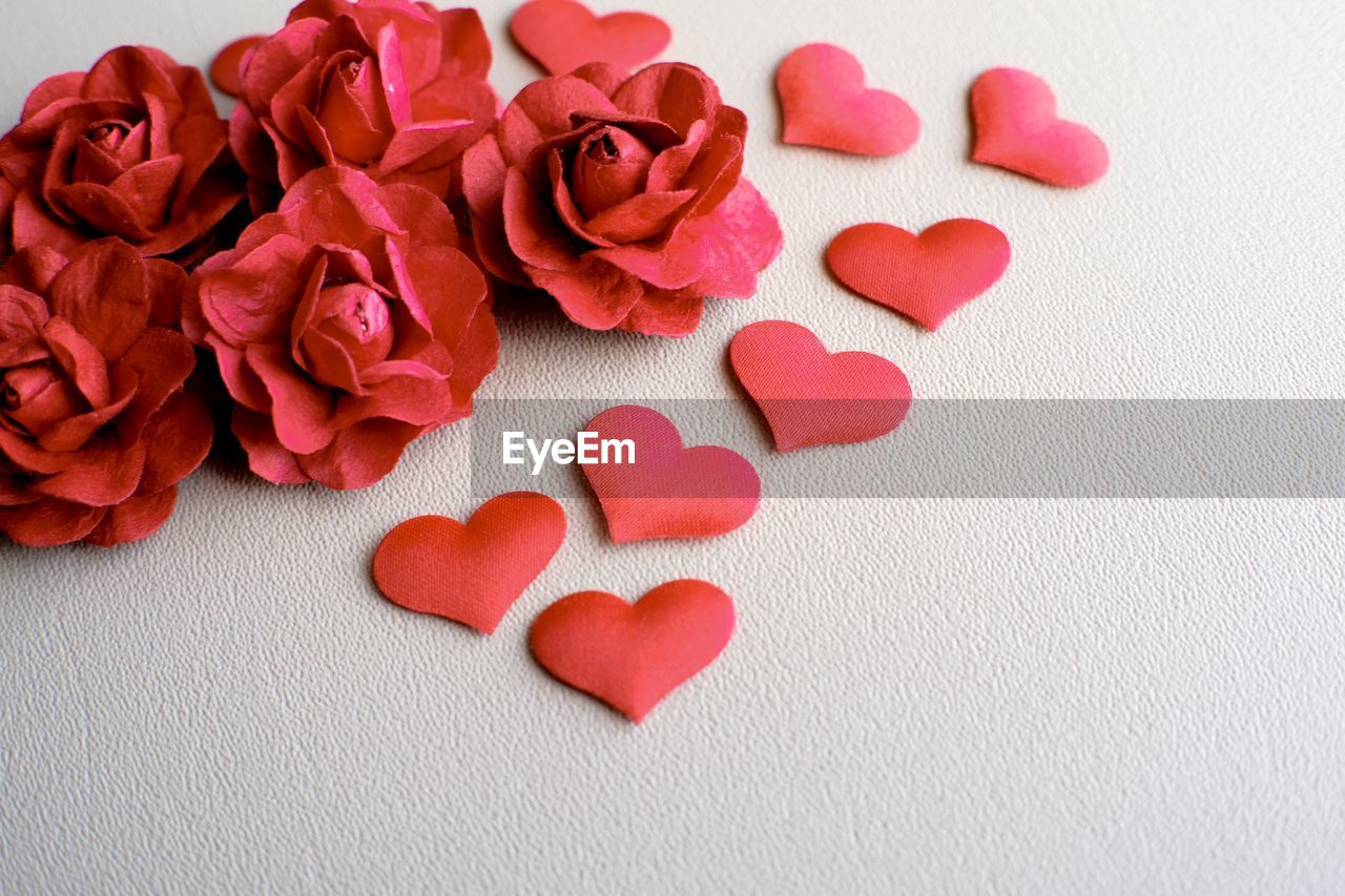 Close-up of red artificial flowers on table