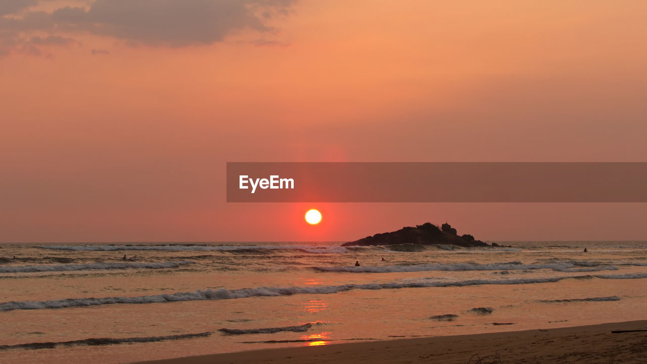 SCENIC VIEW OF SEA AGAINST ORANGE SKY