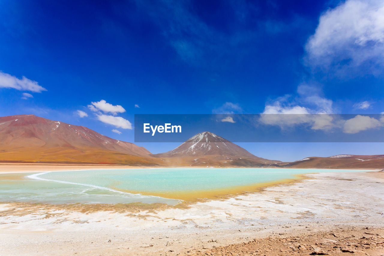 SCENIC VIEW OF BEACH AGAINST BLUE SKY