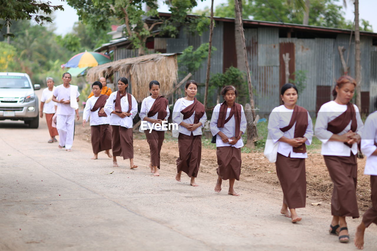 GROUP OF PEOPLE WALKING IN STREET