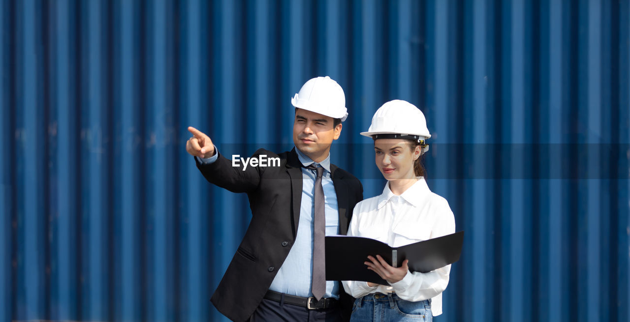 YOUNG MAN WORKING WITH CAMERA IN OFFICE