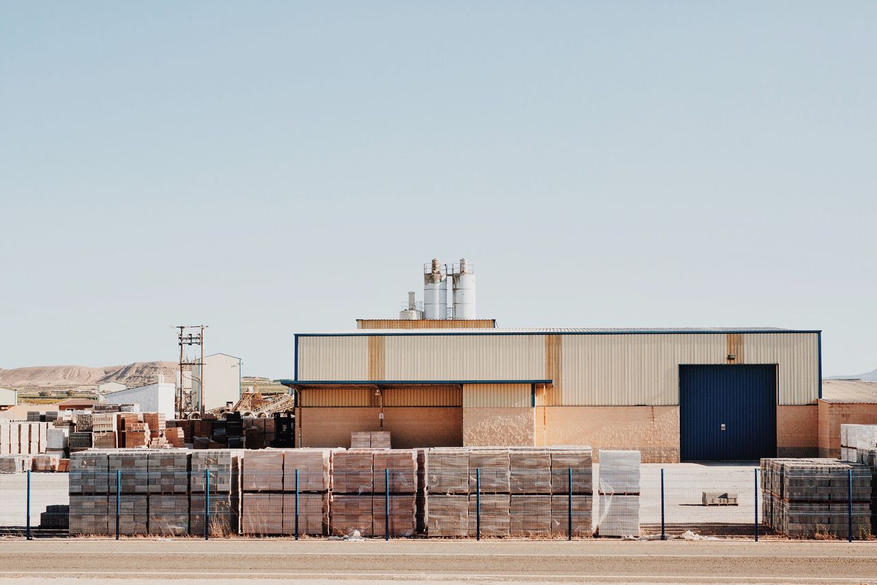 VIEW OF INDUSTRIAL BUILDING AGAINST CLEAR SKY