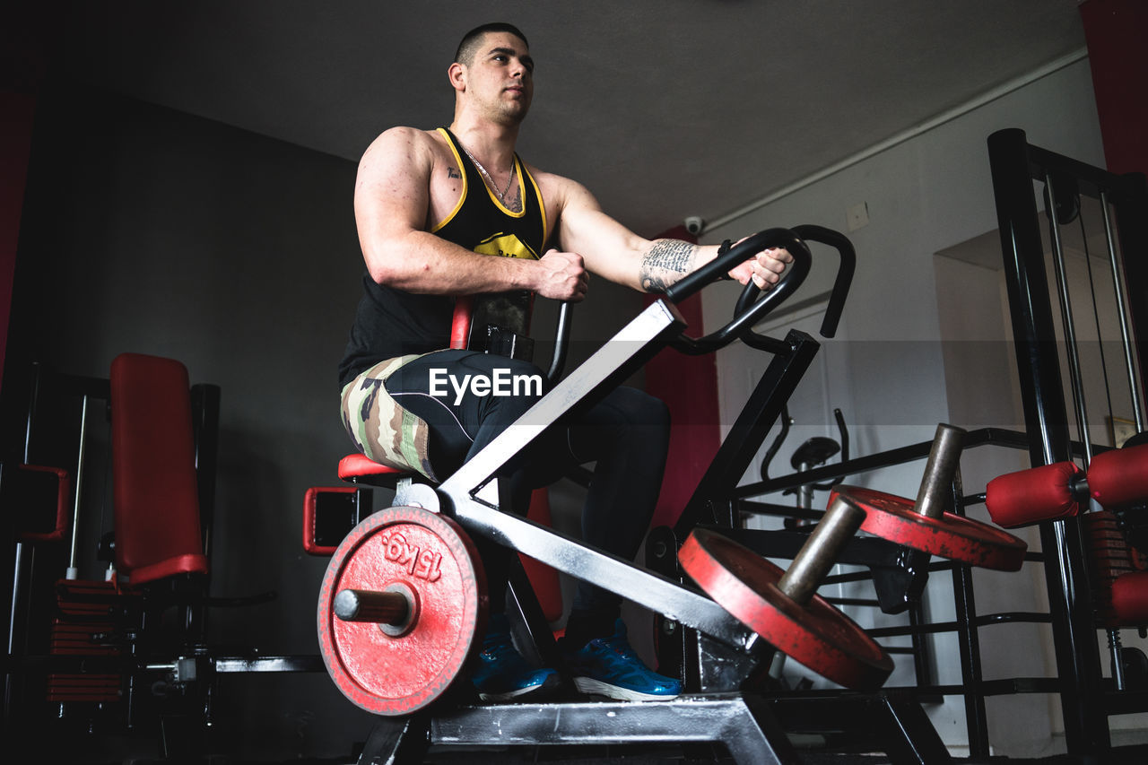 Young man exercising in gym