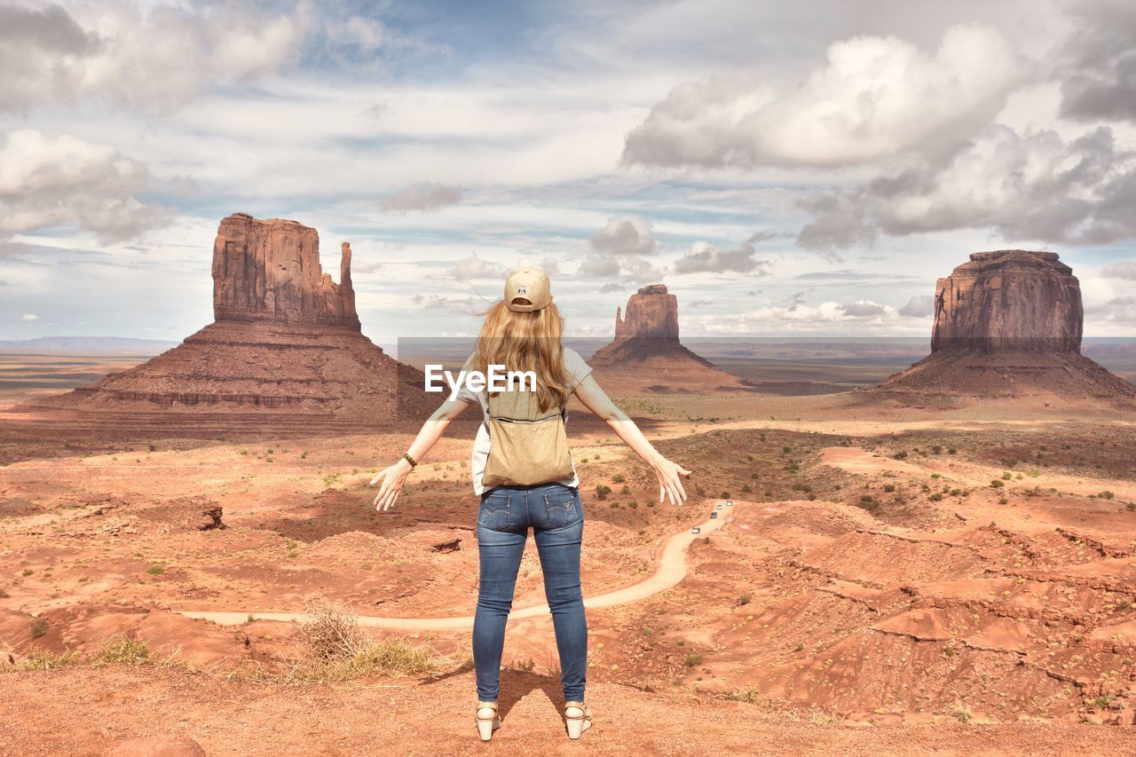 Rear view of woman standing against monument valley