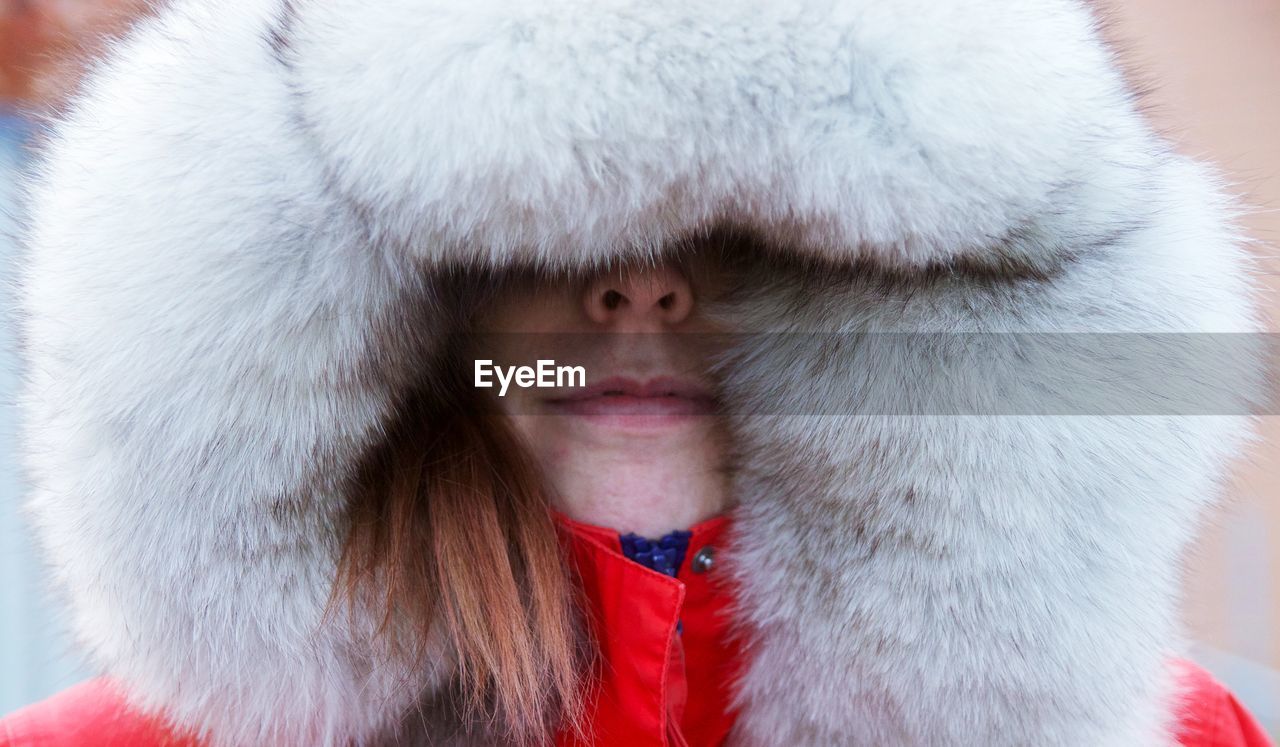 CLOSE-UP PORTRAIT OF CUTE GIRL WITH SNOW IN WINTER