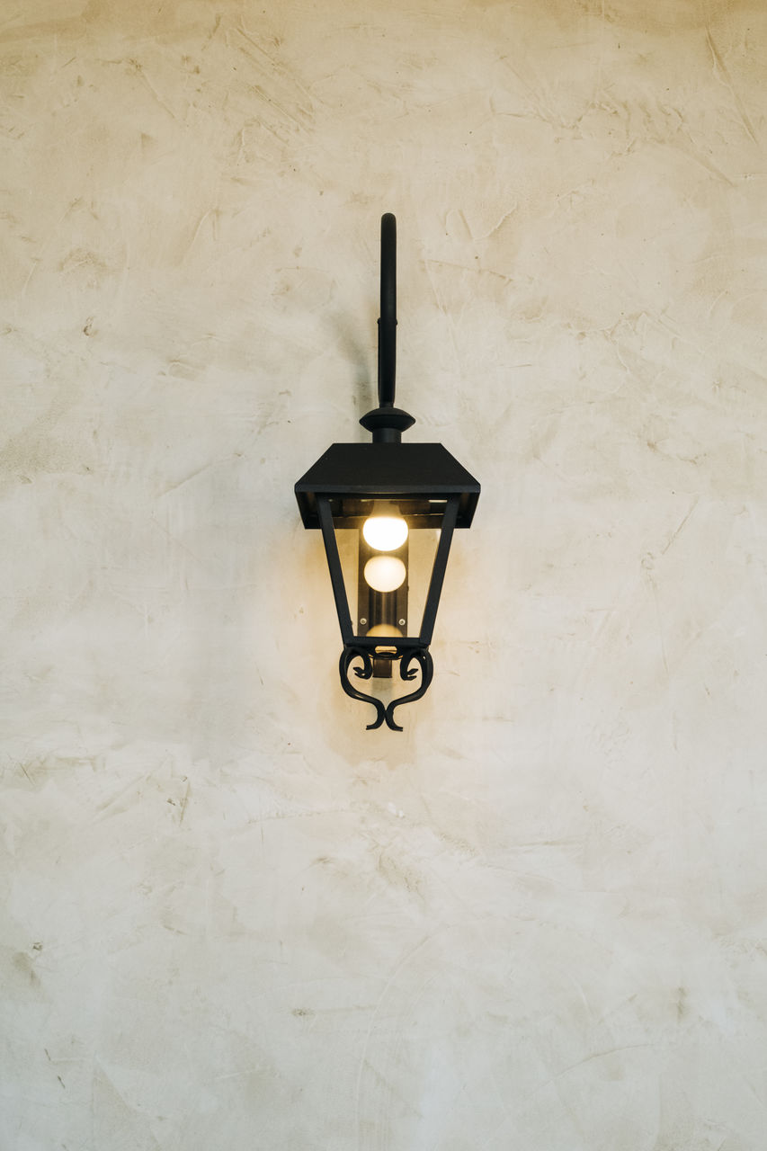 ILLUMINATED LIGHT BULB ON WALL