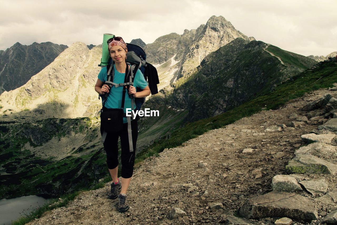 Portrait of female hiker with backpack on mountain