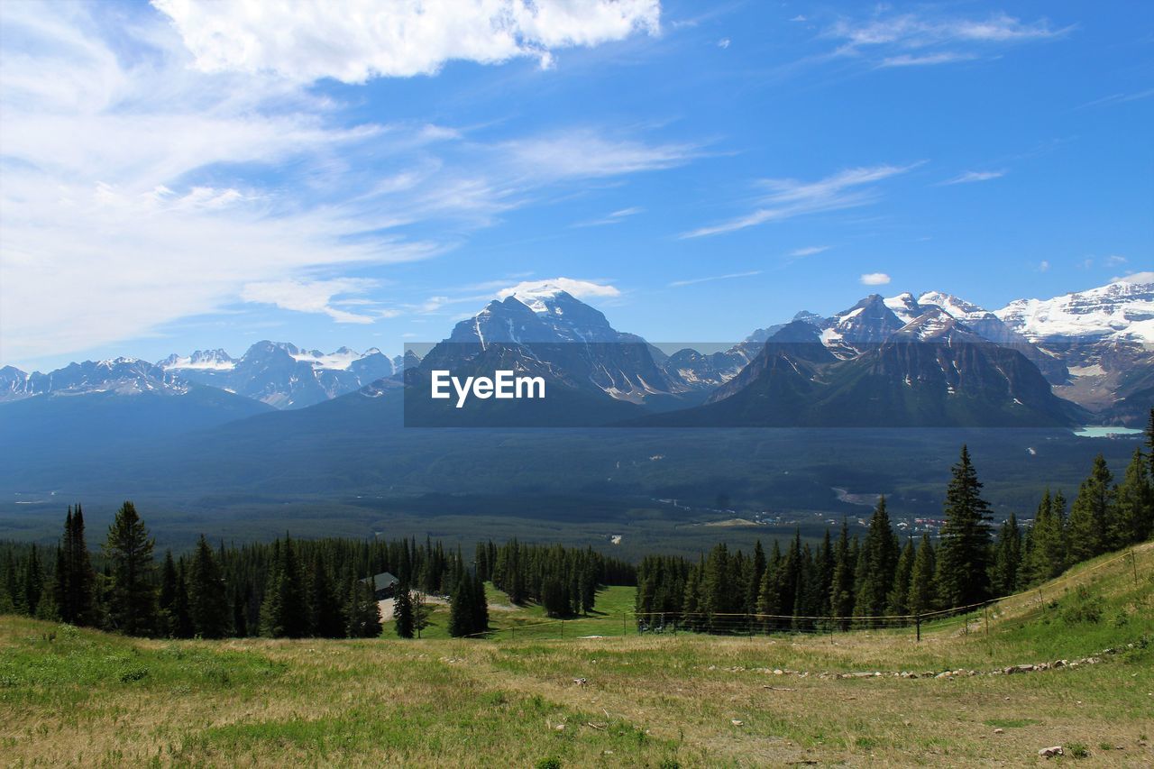 Scenic view of mountains against cloudy sky