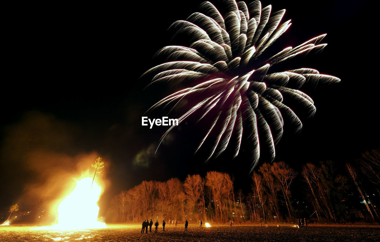 Low angle view of firework display at night