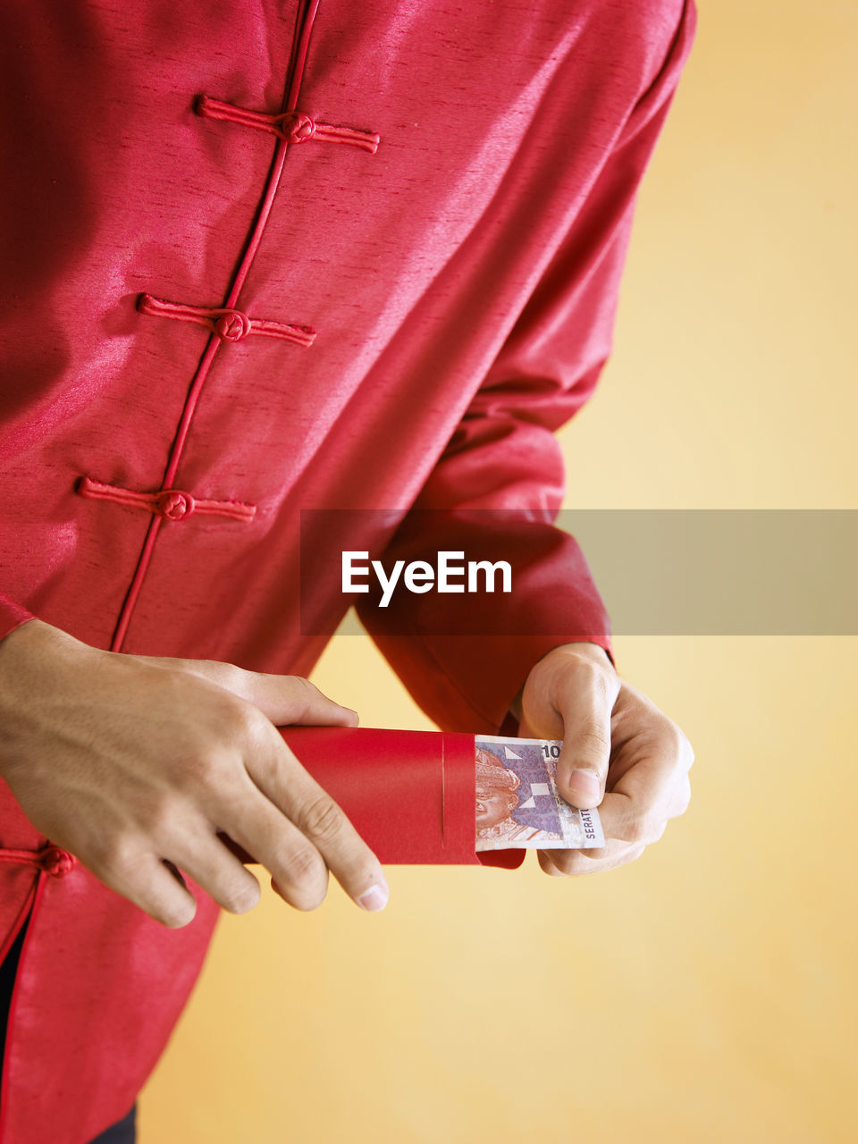 Midsection of man with paper currency in envelope during chinese new year