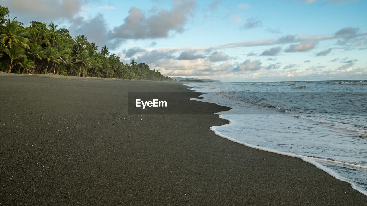 SCENIC VIEW OF BEACH AGAINST SKY DURING SUNRISE