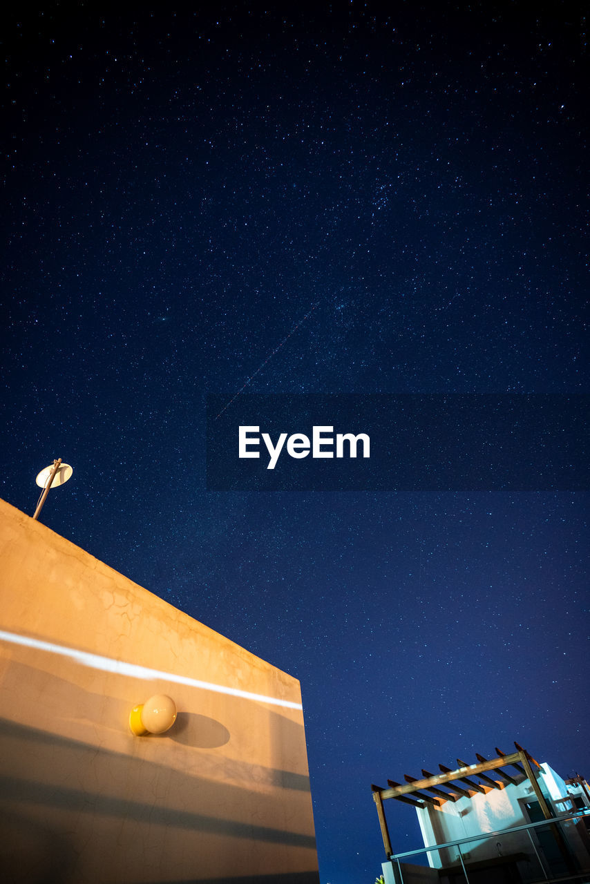 Low angle view of building against clear sky at night