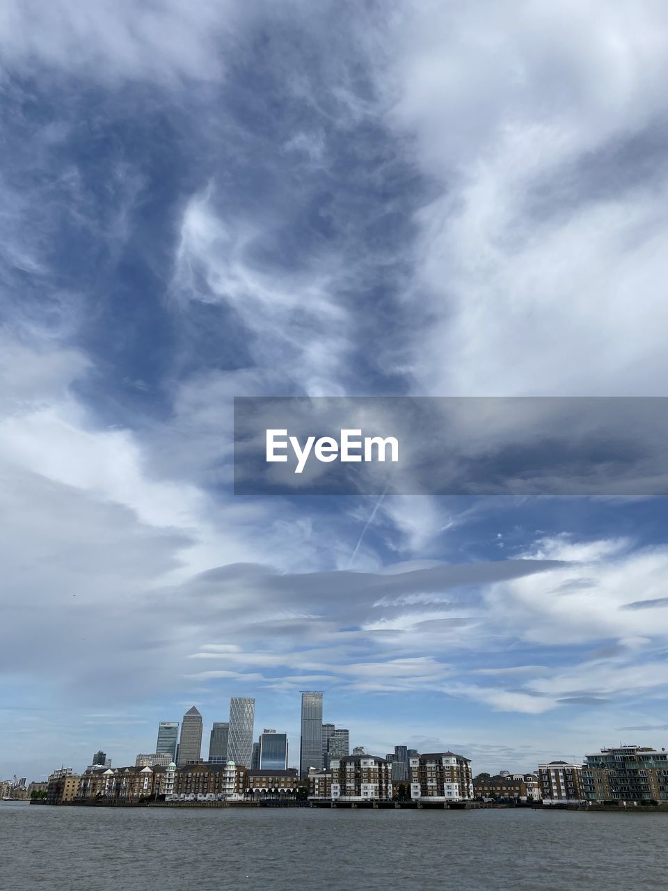 BUILDINGS AGAINST CLOUDY SKY