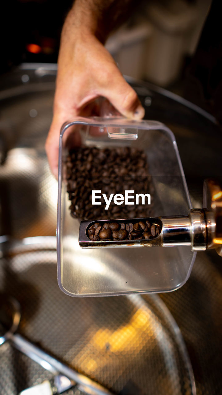 Cropped hand of man preparing coffee