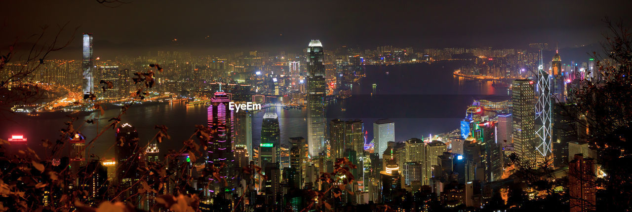 Illuminated cityscape against sky at night