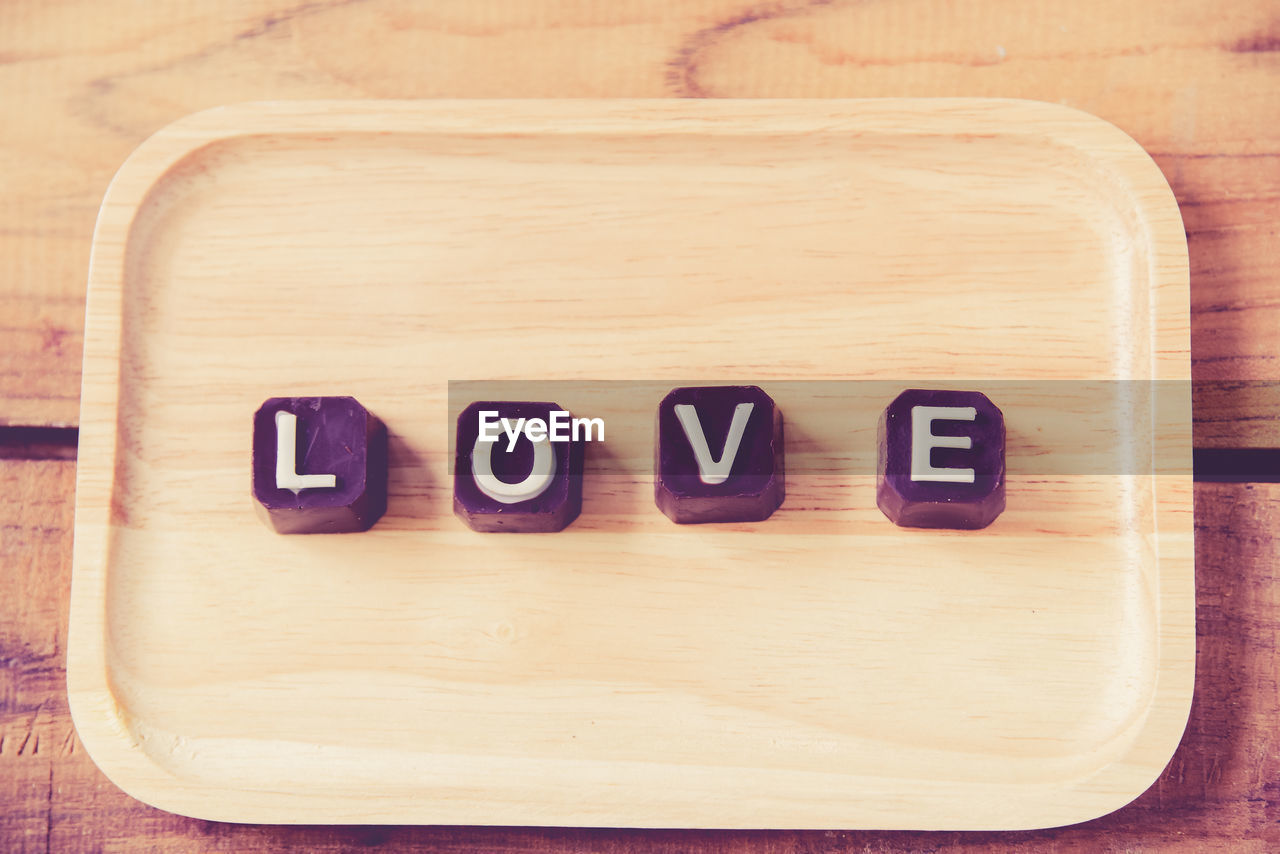 Close-up of love text on chocolates in tray